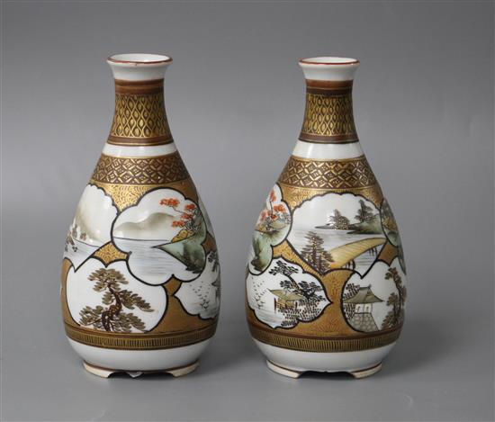 A pair of Kutani porcelain vases, decorated with landscape panels, signed to the underside, height 13.75cm